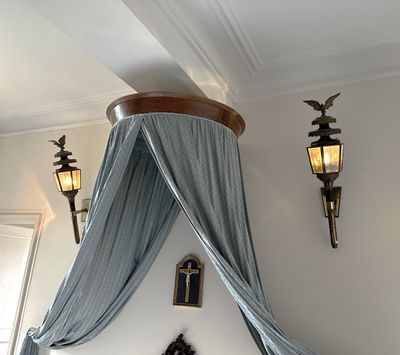 a bed with a canopy over it in a room