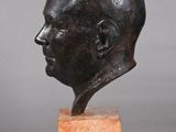 a bronze bust of a man with a bald head on a marble base