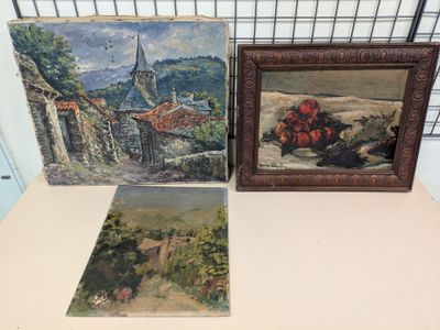 three paintings on a table in front of a wire fence