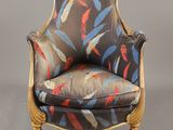 an upholstered chair with colorful feathers on it