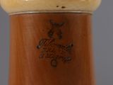 a close up of a vase with a brown handle