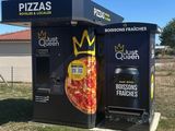 a black box with a pizza on it sitting in the middle of a field