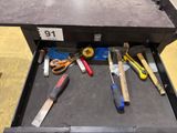 many tools in a tool box on the floor