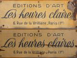 yellow sign with black writing on it that says editions d ' art les heures alive
