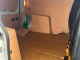 the inside of a van with a cardboard box in the back of it