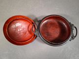 an image of two red pots sitting on top of a table