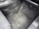 the interior of a car with a carpeted floor and a steering wheel