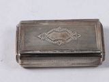 an antique silver cigarette case with a decorative design on the front