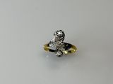 an image of a silver and gold ring on a white surface