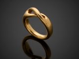 an image of a gold ring with a curved design