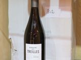 a bottle of wine sitting on a glass shelf