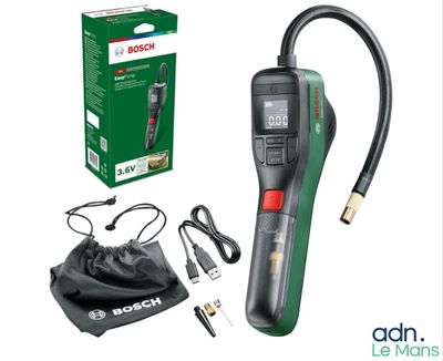 a green and black digital thermometer next to a black bag