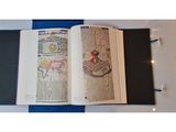 a book open on a table with a drawing on it
