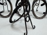 a pair of old fashioned bicycle wheels on a stand