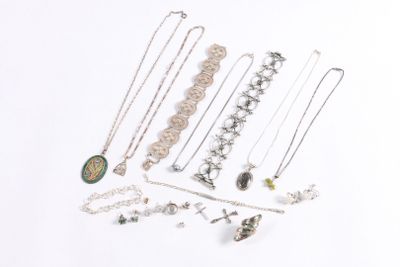 a lot of necklaces and bracelets on a white surface