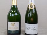 two bottles of champagne sitting next to each other on a table