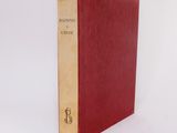 a red book sitting on top of a white surface