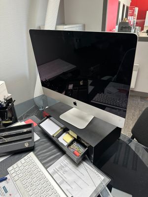 un bureau sur lequel se trouvent un ordinateur, un clavier, une souris et d'autres objets