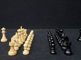 four pieces of chess on a black surface