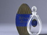 a small bottle of perfume next to a small box