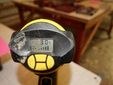 a close up of a yellow and black meter on a table