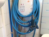 a blue hose attached to a white toilet in a bathroom