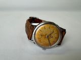 a watch that is sitting on a white surface