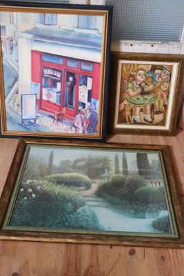 three framed pictures on the floor next to a window
