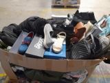 a cardboard box filled with shoes and other items