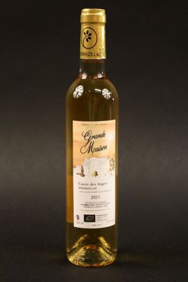 a bottle of wine sitting on top of a black table