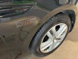 a close up of a car ' s tire on the side of the road