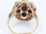 a close up of a gold ring with garnets on it