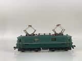 a green train on a white surface with a white background