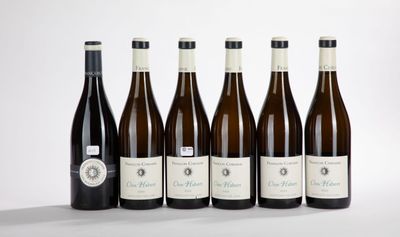 six bottles of wine are lined up in a row