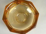 a glass bowl that has a yellow liquid inside of it