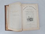 a book opened on a table with a picture of a man on horseback