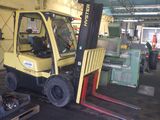 a yellow fork truck that is parked in a warehouse