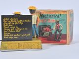 a toy figure of a man with a hat and a sign