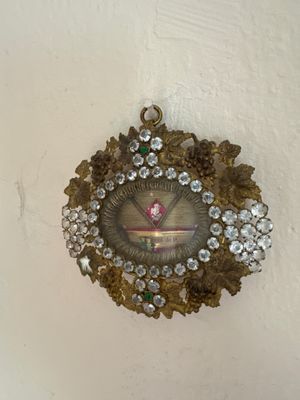 a clock hanging on the wall with a bunch of jewels