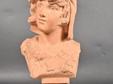 a close up of a clay bust of a woman on a pedestal