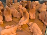 a lot of clay figurines in a glass case