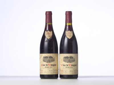two bottles of red wine sitting on top of a table