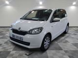 a picture of a white car parked in a garage