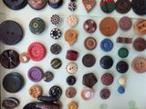 many different types of buttons arranged on a table