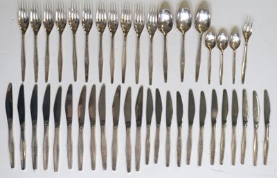 many forks and spoons laid out on the table