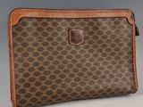 a brown and tan purse with a brown leather handle