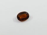 an oval shaped brown sapphire stone on a white surface