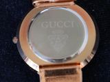 a close up of a watch on a blue surface