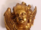 brass angel head with wings on a white background