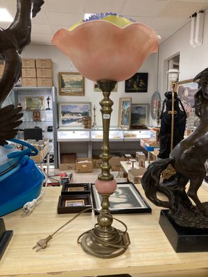 a table with a lamp and a statue on it